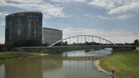 kayaking under a modern bridge in a city