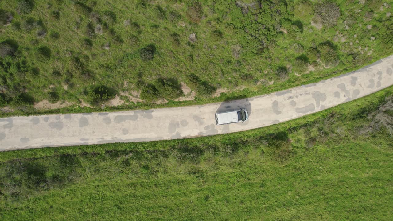 Aerial Birds Eye View Over Camper Van Driving Along Winding Road In Bordeira, Portugal