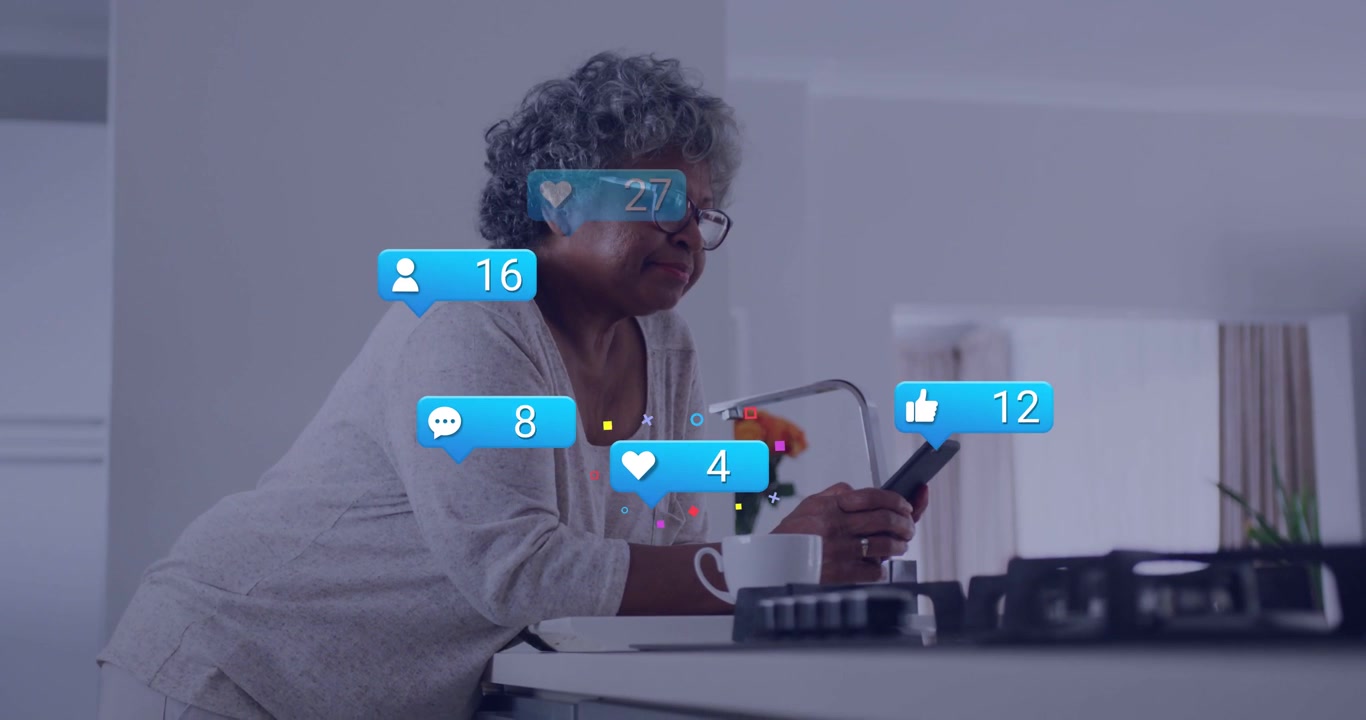 Senior woman leaning on counter, alert appearing, tapping phone, tracking social media blue bubbles