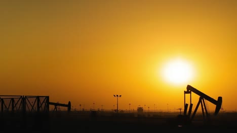 oil pumps time lapse at sunset - pan