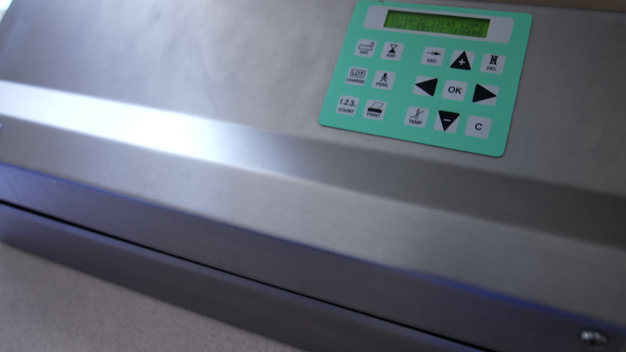 Preparation of device and tools for surgical operation. Medical staff arranges tools into a plastic bag for sterilization in modern sterilizer equipment.
