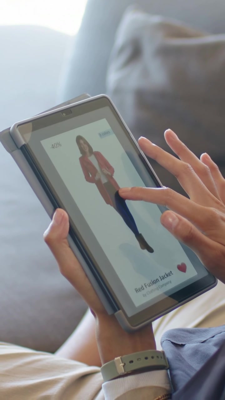 Vertical video: Order prompt appearing, woman tapping foldable phone folio on couch, zooming jacket