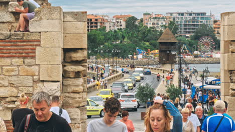 people walk through pedestrian cobblestone streets of ancient nessebar