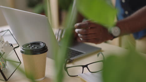 businessman hands typing using laptop keyboard drinking coffee beverage sending email message browsing online internet