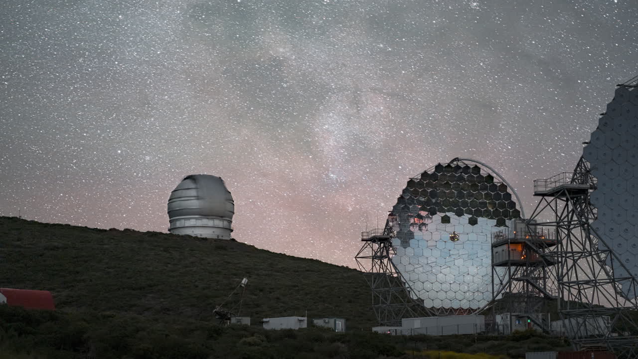 Majestic view of telescopes at Roque de los Muchachos Observatory under a starry sky, timelapse