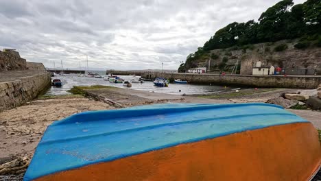 colorful boat on sandy shore by the bay