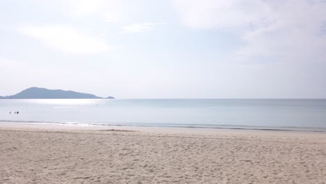 summer video 4k of the beach with coconut palm tree in sunshine daytime with white sand beach and clear blue sky skowmotion 4k uhd video