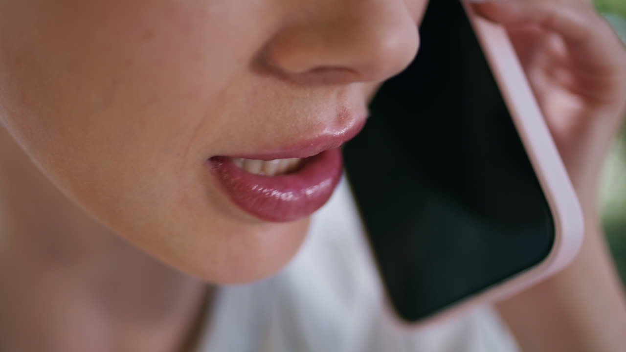 Closeup lips woman calling by smartphone smiling outdoors. Female mouth speaking
