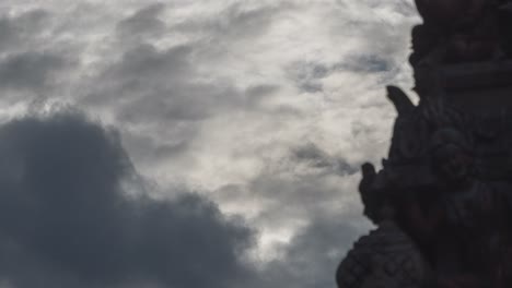 temple sculpture against a cloudy sky