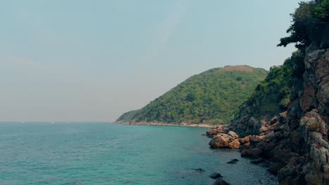 low flight over azure ocean by picturesque hilly islands