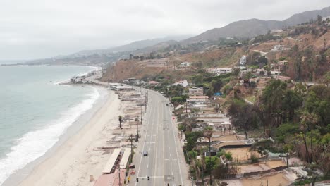 aerial wide tilting up shot of the pacific coast highway at las flores canyon in malibu after the wildfire in los angeles, california. 4k