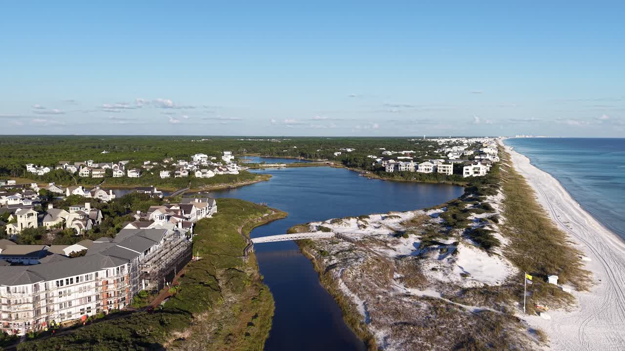 Drone fly at Camp Creek Lake with local apartments and bridges near white sandy beach, 30A, Florida, USA