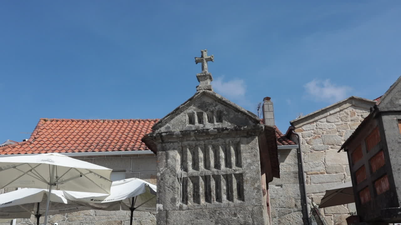 Traditional Spanish hórreos under a clear blue sky in Combarro, Pontevedra, Galicia