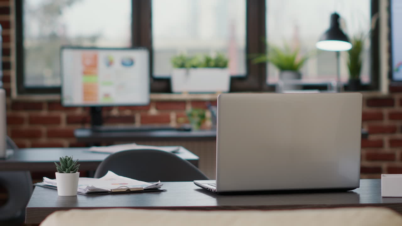 Nobody at office desk with charts documents and laptop