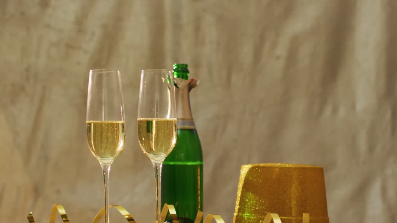 Champagne glasses and decorations on green background at new year's eve