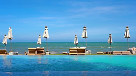 Umbrella-around-outdoor-pool-nearly-sea-ocean