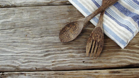 wooden spoon and fork with napkin on table