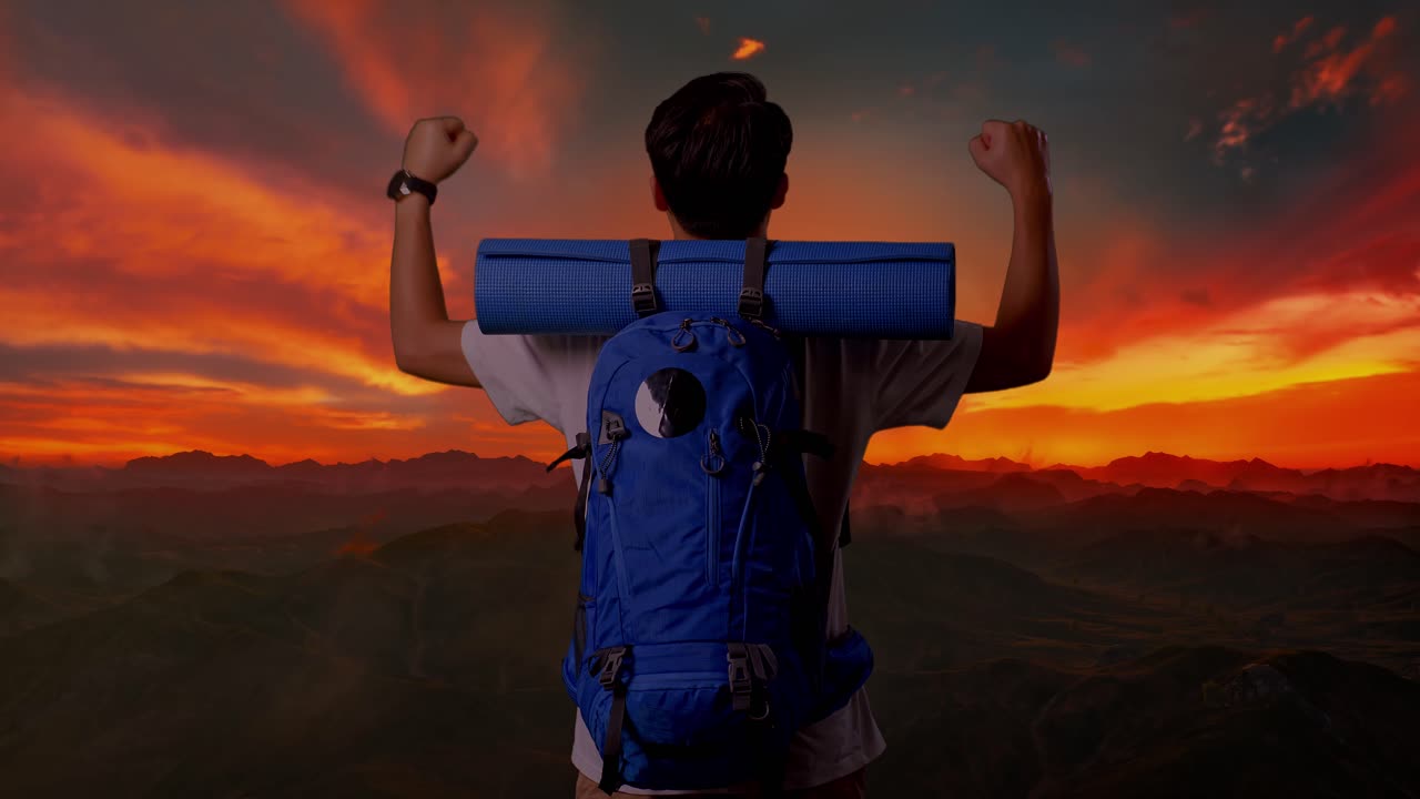 Hiker Reaches Summit at Sunset