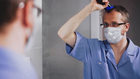 doctor-cuts-hair-on-head-with-modern-machine-near-mirror