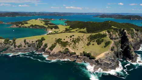 largest island in the bay of islands with lush green hills, dramatic cliffs, idyllic bays, and sandy beaches