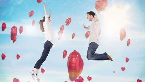 happy couple jumping with hearts