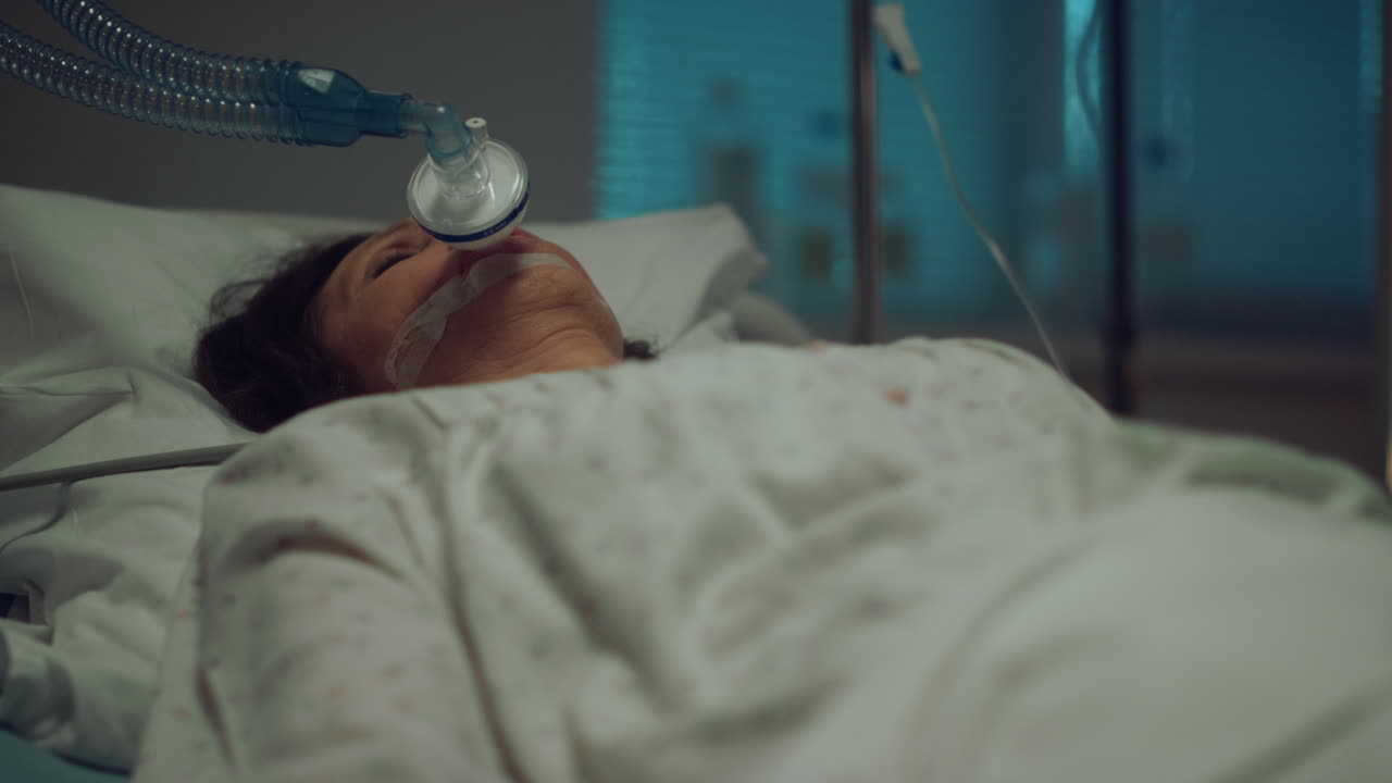 Sick patient oxygen mask resting in hospital. Pulse oximeter on finger closeup.