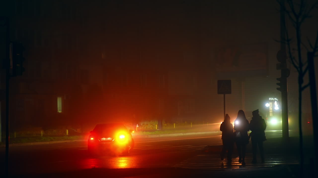 Foggy Night City Street Scene with People and Cars
