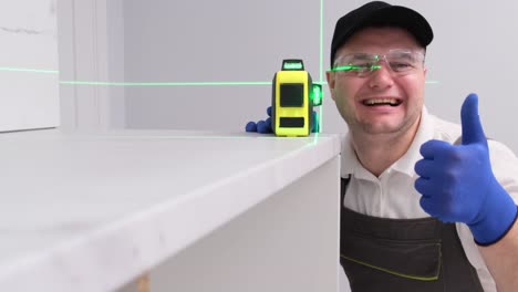 man using laser level for home improvement
