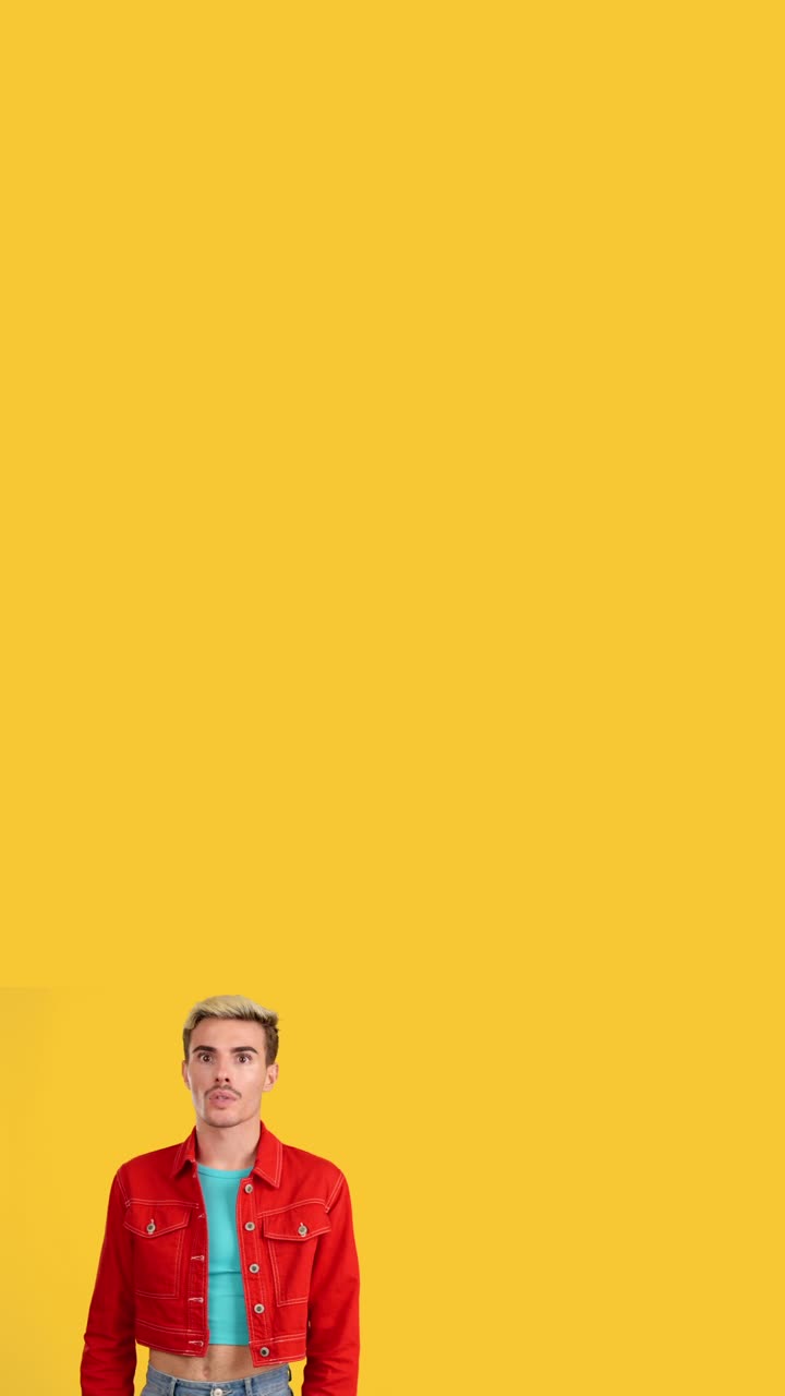 Man in red jacket pointing and looking up