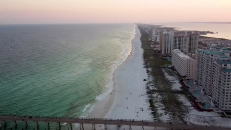 aerial view of navarre beach pier, florida pier and beach, pensacola beach along florida's gulf coast at sunset dusk with beautiful sky. drone view of navarre pier in west florida. santa rosa island