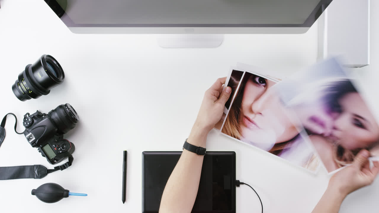 Top view photographer graphic designer chosing beauty images working at desk from above - Red Epic Dragon