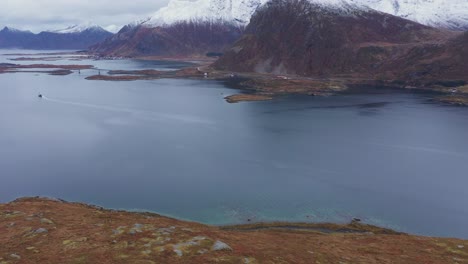 flying from land over a fjord in norway near lofoten