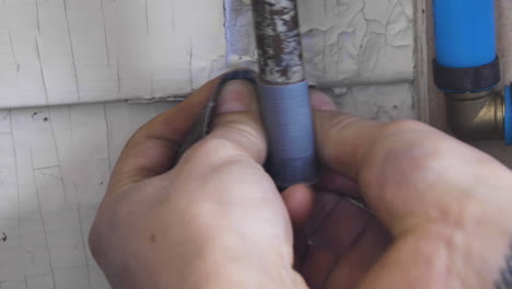old copper pipe before sanded down before being welded together. right pan, closeup.