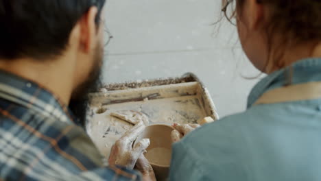 couple learning pottery