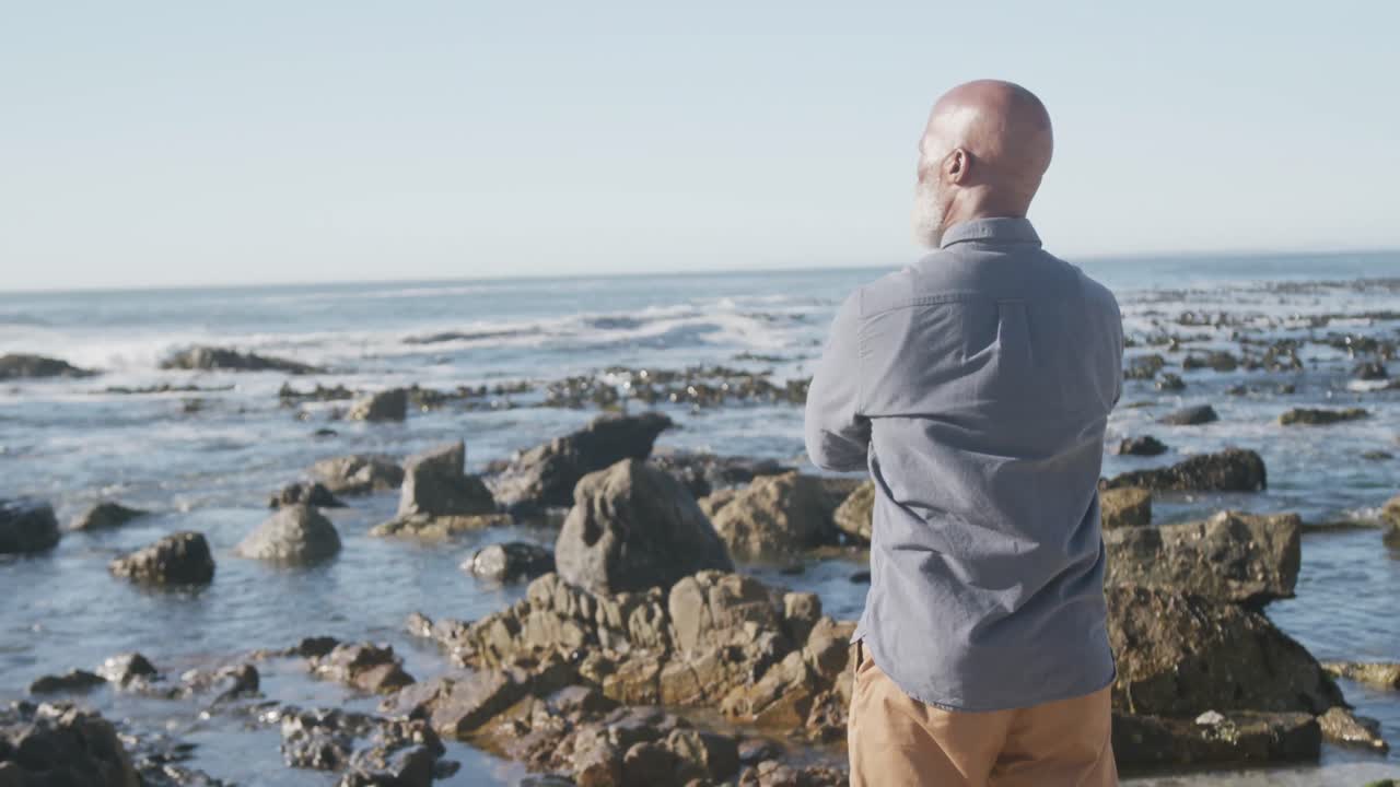 Senior african american man at beach, copy space, slow motion