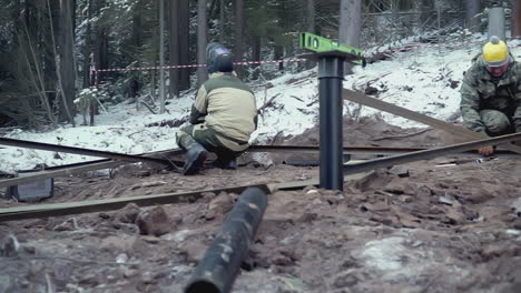 welding metal supports for foundation in snowy forest