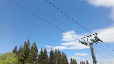 Empty Chairlift Seat passing above, on a sunny summer day