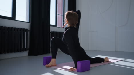 young woman practicing yoga in a studio