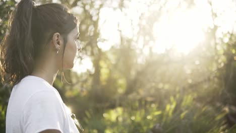 slowmotion tracking shot of a young woman walking through a nature trail