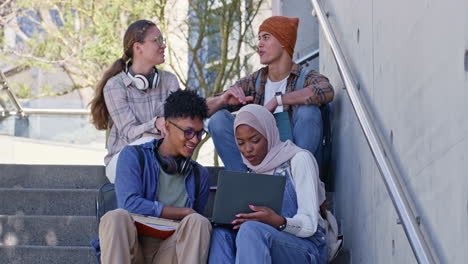 group of diverse students studying together on campus stairs