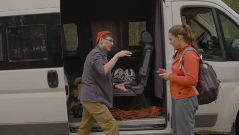 couple gathering the equipment for climbing