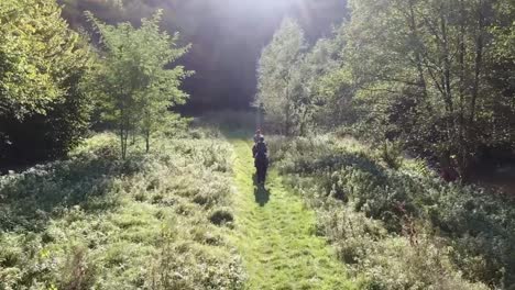 Boy-and-a-girl-are-riding-horses-through-the-forest-by-the-river