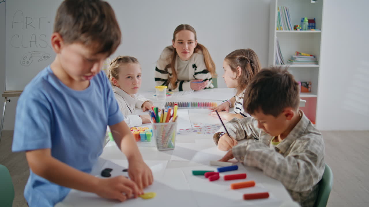 Inspired children enjoying art lesson in elementary school class room closeup