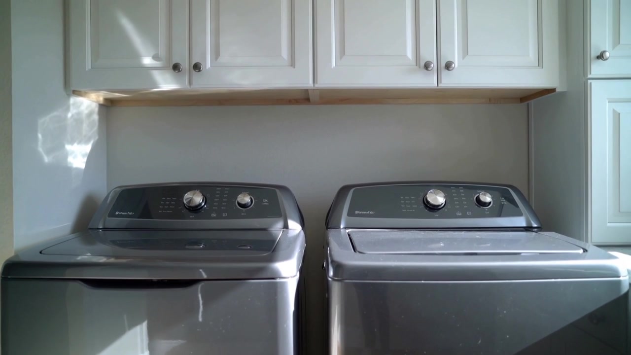 Sunlight entering right window moving across washer and dryer in laundry room as sun angle shifting