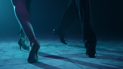 dancers legs exercising latin movements. ballroom couple feet dancing indoors.