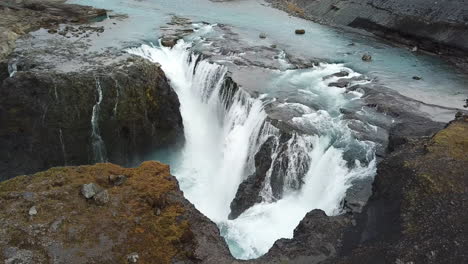 orbit aerial view on amazing cascade waterfall and river canyon