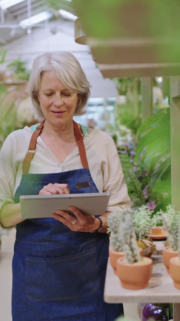 Woman using tablet in greenhouse