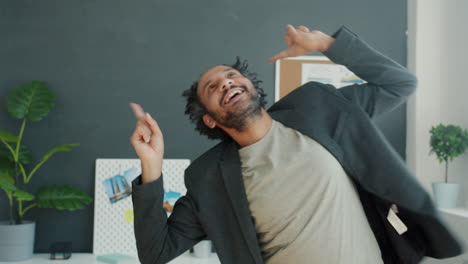 happy businessman dancing in office