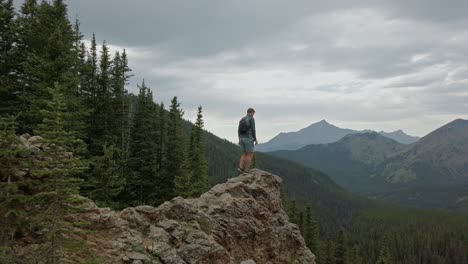 hiker stepping on ledge circling rockies kananaskis alberta canada