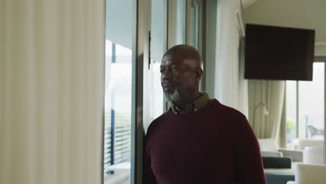 video of lonely thoughtful senior american african men in living room